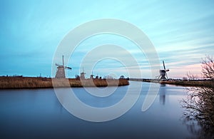 Windmills and water canal on sunset in Kinderdijk, Holland