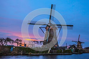 Windmills and water canal on sunset in Kinderdijk, Holland