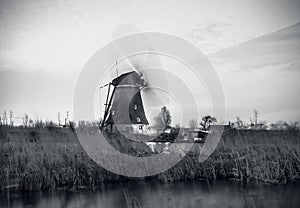 Windmills and water canal on sunset in Kinderdijk, Holland