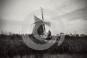 Windmills and water canal on sunset in Kinderdijk, Holland