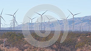 Windmills on wind farm, wind mill energy generators. Desert windfarm, USA.