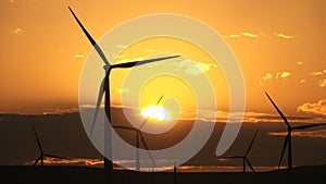 Windmills or wind turbine in sunrise light