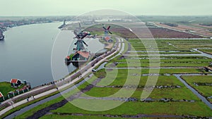 Windmills of the Zaans Museum in Netherlads, surrounded by green fields and water