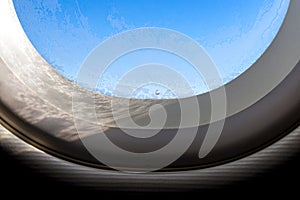 The window of the airplane. A view of porthole window on board an airbus for your travel concept or passenger air transportation