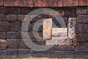 Window on ancient laterite wall in historical park