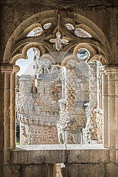 The window of the ancient medieval castle in the Gothic style from which can see the beautiful carved towers of the castle. photo