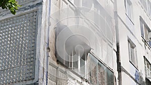 Window of an apartment building from which smoke comes out. Side view. Fire. Russia, Stavropol, 1.05.20