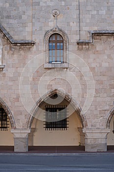 Window arch and column of an old antique church.Decorated with cement paintings of the ancient Greeks