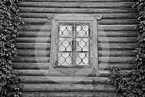 Window behind iron bars on a wall black and white