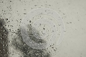 close-up: window with big raindrops durring the heavy rain photo