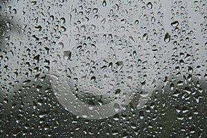 close-up: window with big raindrops durring the heavy rain photo