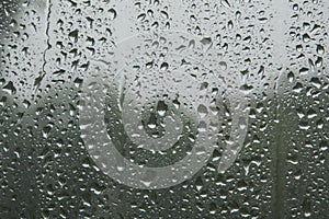 close-up: window with big raindrops durring the heavy rain photo