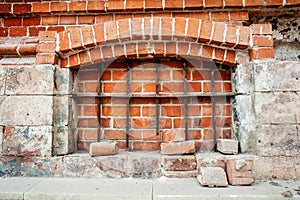 Window blocked with grid and bricks