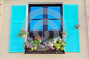 Window with blue shutters and flowers