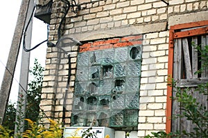 Window with broken glass blocks. Glass blocks in a window on a brick wall.