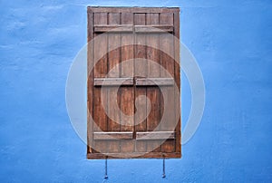 The window with the brown shutter in the blue wall. Cyprus