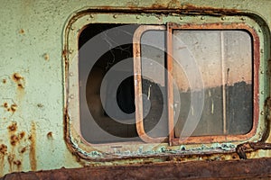 The window in the cabin of the old ship.  Tanker parking