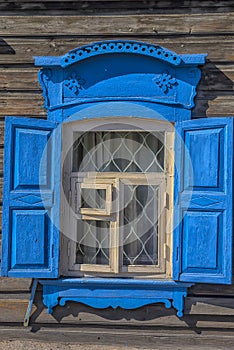 Window with carving architraves and closed shutters.