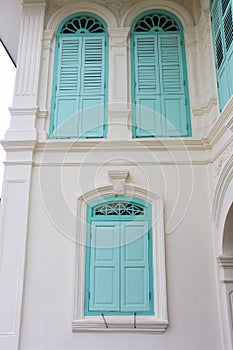 Closed green window in Chino-Portuguese style photo