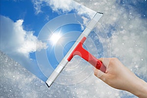 Window cleaner using a squeegee to clean the sky above