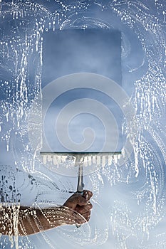 Window cleaner using a squeegee to wash a window