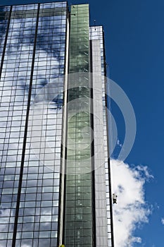 Skyscraper with window-cleaners high up.