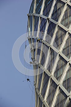 Window cleaners work on building