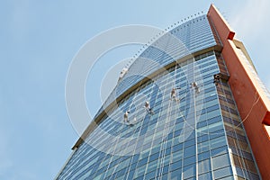 Window cleaners work on building