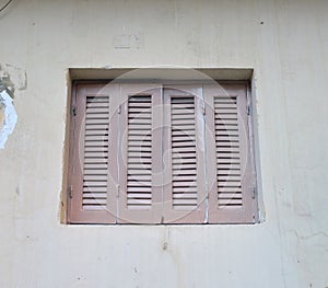 Window closed shutters on the wall of a house