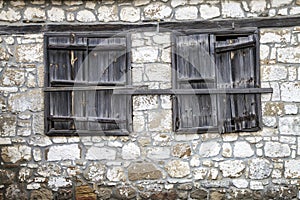 Window with closed weathered wooden shutters