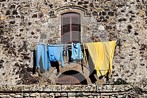 Window and clothes hanging. Wall facade old house.