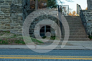 A Window in a Cobblestone Wall With Steps Next to It