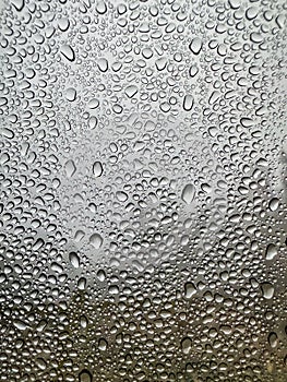 Window with condensation droplets on the inside, creating an abstract pattern.
