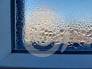 Window covered with frozen drops of condensate water