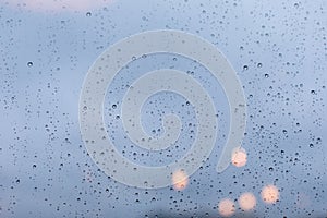 A window covered with raindrops, a wet window during a heavy downpour. Glass surface texture, large drops of water