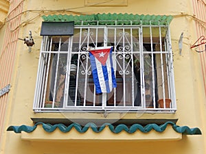 WINDOW WITH CUBAN FLAG, HAVANA, CUBA