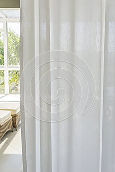 Window with curled white curtain