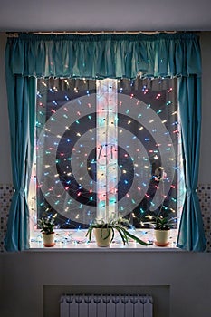 Window decorated with colorful luminous lamps in a photo