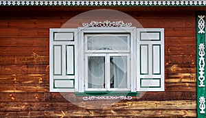 Window with decorative wooden shutters