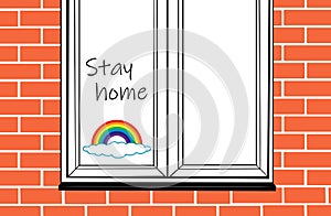 Window detail with a drawing of a rainbow cloud and the message `Stay home`.