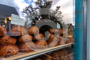 A window display of pastries with a sign that says \