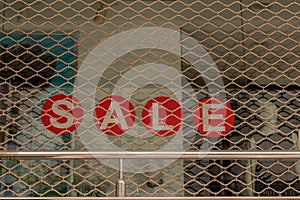 Window display with red sale board inside the shop at Bengaluru, India