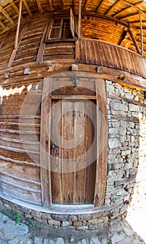 Window and door - an element of the stone-wooden architecture of the mountain village of Zheravna in Bulgaria