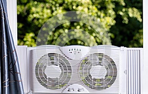 Window fan ready to cool down room in home during hot weather