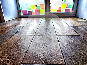 Window and floor. Background, texture. Frosted Glass Door With Colorful Square Details in a Wooden Interior
