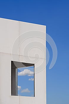 Window frame on brick smartboard wall pattern of incomplete house structure in construction site against blue sky