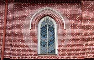 Window frame and red brick of exterior of main church at cathedral of the holy trinity.