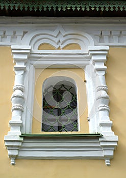 Window in a frame of a stone platband. A fragment of church of Christmas of John the Forerunner on Volga, the 17th century. Uglich