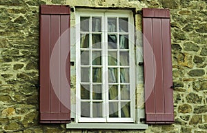 Window Framed Against A Stone Wall