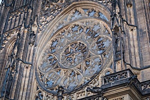 The window on the front of the gothic Vysehrad cathedral in Prague featuring beautiful windows and stone wall and pillars